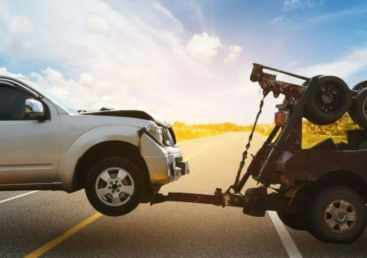 accident damaged car being towed away