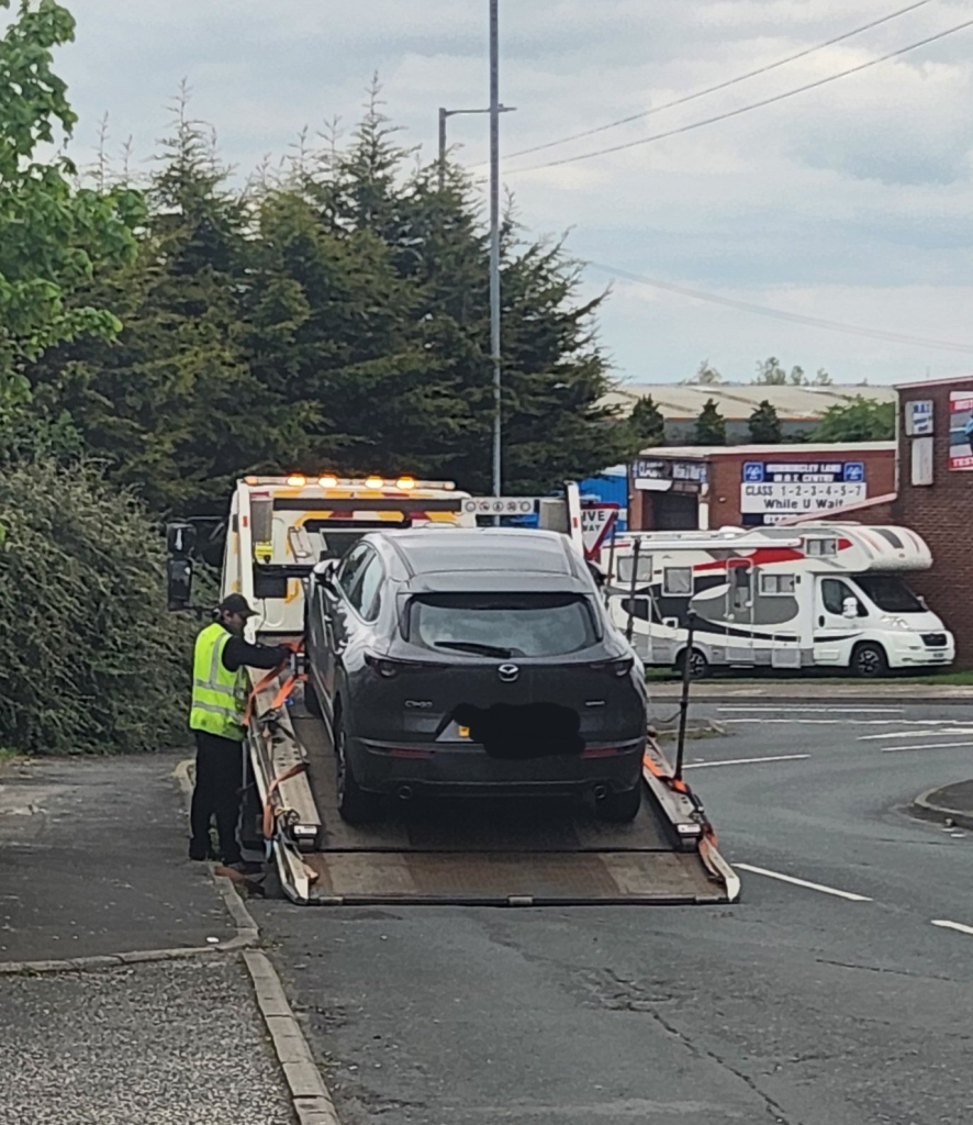 Car being loaded onto a trailer in London, 24/7 pay-as-you-go recovery from Manchester to Birmingham.