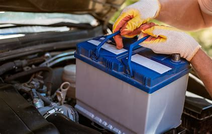Hand pointing to car battery – mobile jump-start service in Keighley