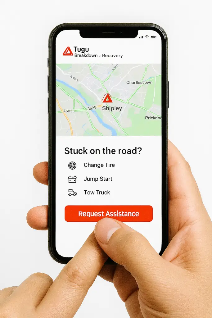 Hand holding smartphone displaying Tugu Breakdown Recovery app interface, showing live roadside assistance request with real-time tracking and emergency service options.